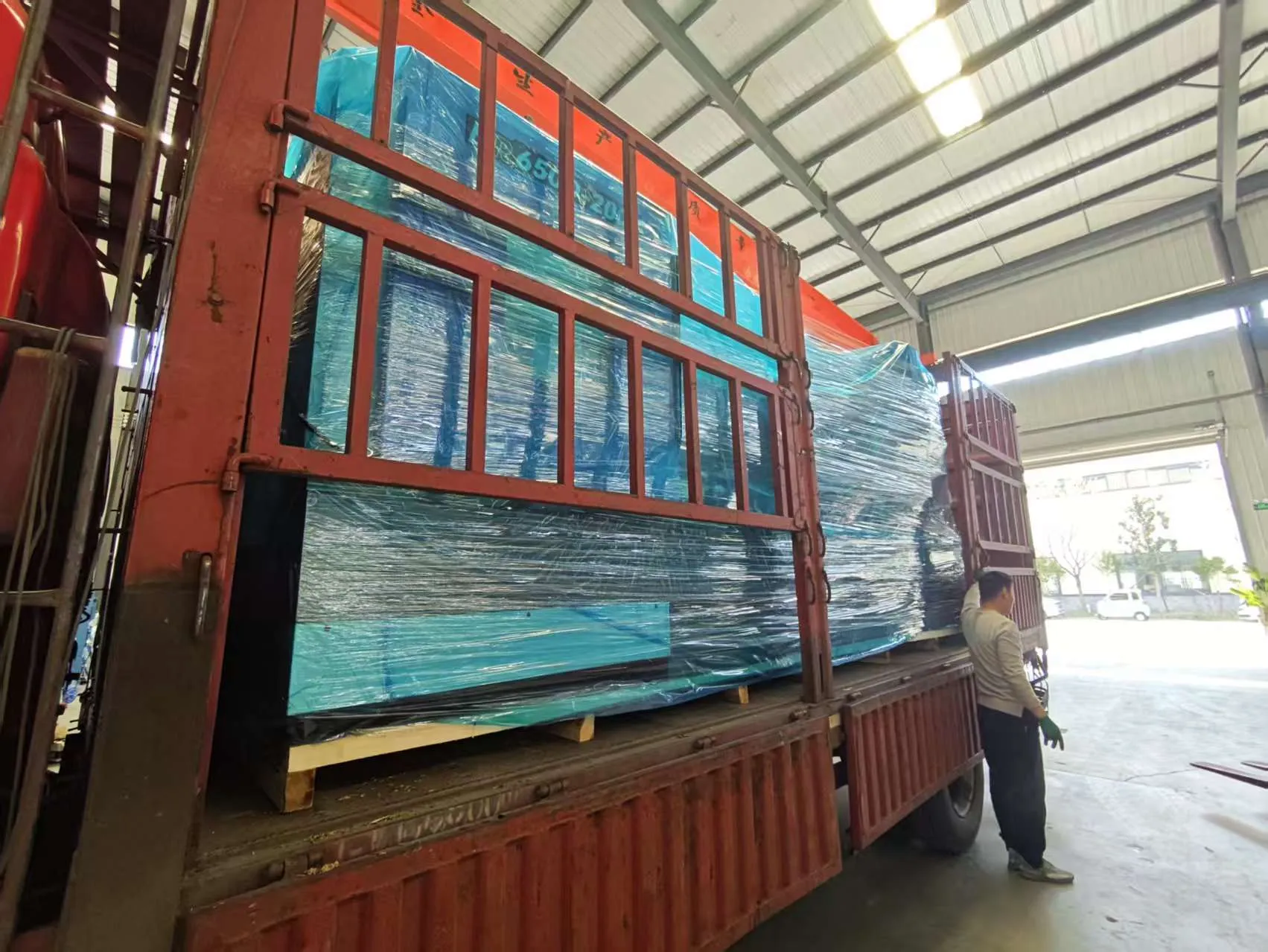 CNC lathe machine securely packed and loaded on transport trailer
